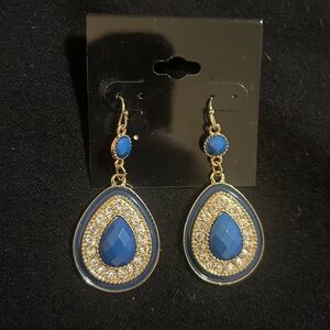 New earnings in gold with blue center stone surrounded by white stones.